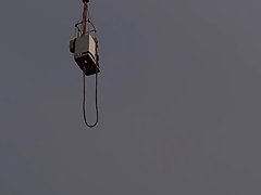 Naked babe is about to do her first bungee jump, while many people are watching her